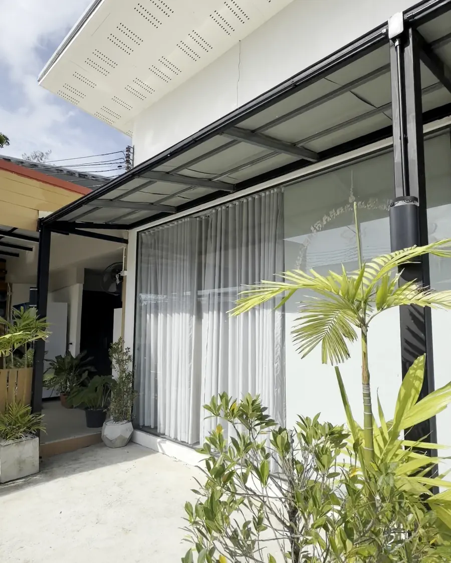 Entrance of LUNA LIFE Spa with glass front and plants